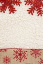 Red and brown snowflake border winter background on beige sherpa material