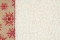 Red and brown snowflake border winter background on beige sherpa material