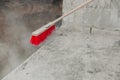 a red brush and a wall in some cement that has been guted down Royalty Free Stock Photo