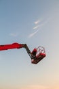 Red bucket crane mounted on truck