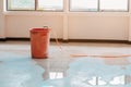 Red bucket underlie water leak interior office building in from Ceiling Royalty Free Stock Photo