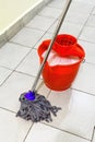 Red bucket with washing water and mop the floor Royalty Free Stock Photo