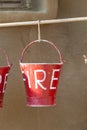 Red buckets filled with sand used as fire fighting equipment Royalty Free Stock Photo