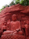 A Red Buddha Sculpture with servants Royalty Free Stock Photo