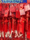 Red buddhists praying and hanging traditional wishing cards