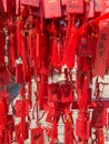 Red buddhists praying and hanging traditional wishing cards