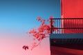 a red building with a balcony and a plant on it Royalty Free Stock Photo