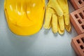 Red building bricks protective hard hat leather safety gloves on Royalty Free Stock Photo