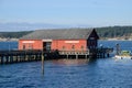 Red building on Coupeville Wharf at high tide in Penn Cove