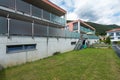 Red building exterior with large garden and glass parapet