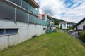 Red building exterior with large garden and glass parapet