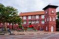 Red building of Stadthuys with a beautiful yard during the daytime in Melacca City, Malaysia