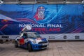 Red Bull advertising Mini Cooper car with logo. Giant Red Bull energy drink can on the car\'s roof