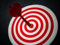 Red bullseye dart arrow hitting target center of dartboard. Concept of success, target, goal, achievement Royalty Free Stock Photo