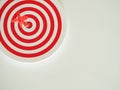 Red bullseye dart arrow hitting target center of dartboard  on white background Royalty Free Stock Photo