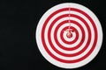 Red bullseye dart with red arrow hit center