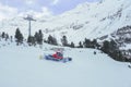 Red bully pisten on winter snow mountain with ski cable Royalty Free Stock Photo