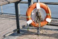Red buoy life safety ring on post at riverbank Royalty Free Stock Photo