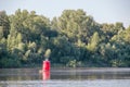 Red buoy on quiet river on summer day. Royalty Free Stock Photo