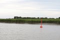 Red Buoy in the River Royalty Free Stock Photo