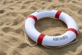 Red buoy on sand with word of welcome aboard Royalty Free Stock Photo