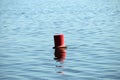 Red buoy on a sea surface with waves Lithuania Royalty Free Stock Photo