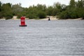 Red buoy on the water in the river Royalty Free Stock Photo