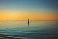 Red buoy on the water. A seagull sits on a lighthouse