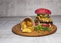 Red burger with meat and fried potatoes in pita bread Royalty Free Stock Photo