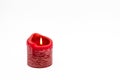 A red burning candle isolated on white background as Christmas card