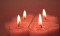 Red burning heart-shaped candles blazing flames. Tongues of fire, red background Royalty Free Stock Photo