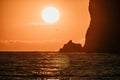A red burning sunset over the sea with rocky volcanic cliff. Abstract nature summer or spring ocean sea background Royalty Free Stock Photo