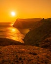 A red burning sunset with the silhouett of a cliff and castle over the sea Royalty Free Stock Photo