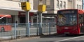 Red bus approaching a speed camera, Plymouth City Centre, UK