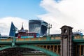 Red Bus crossing Southwark Bridge against skyscrapers in the City of London Royalty Free Stock Photo