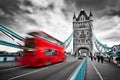 Red bus in motion on Tower Bridge in London, the UK