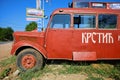 A red bus similar to that used in the movie `Who`s Singin` Over There`, directed by Slobodan Sijan, with the text `Krstic & S