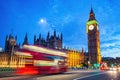 Red bus on Westminster bridge next to Big Ben in London, the UK at night Royalty Free Stock Photo