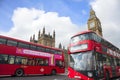 Red buses in front of Houses of Parliament