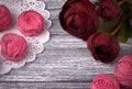 Red buttercup flowers ranunculus white and pink zephyr marshmallows lacy paper napkin on gray wooden background. Copy space. Woman Royalty Free Stock Photo