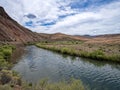 Red buttes rise above the banks of the Owyhee River in southwestern Oregon, USA