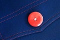 Red button on blue textile Royalty Free Stock Photo