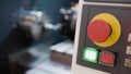 Red button of control panel machine processing metal, industrial background Royalty Free Stock Photo