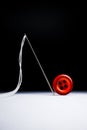 Red button thread needle isolated fashion design concept Royalty Free Stock Photo