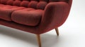 Red buttoned sofa, mid-century modern design, on white background, home decor Royalty Free Stock Photo
