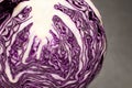 red cabbage ball cut in half with all the leaves on a black gran Royalty Free Stock Photo