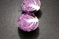 red cabbage ball cut in half with all the leaves on a black gran Royalty Free Stock Photo