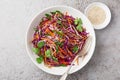 Red cabbage, carrot and bell pepper cole slaw salad, healthy vegan salad in white bowl Royalty Free Stock Photo