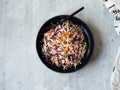 Red cabbage, carrot, cabbage coleslaw salad on black plate on grey background. Top view Royalty Free Stock Photo