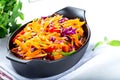 Red cabbage and carrot salad with green onion and cheery tomatoes. Coleslaw for autumn or winter season Royalty Free Stock Photo